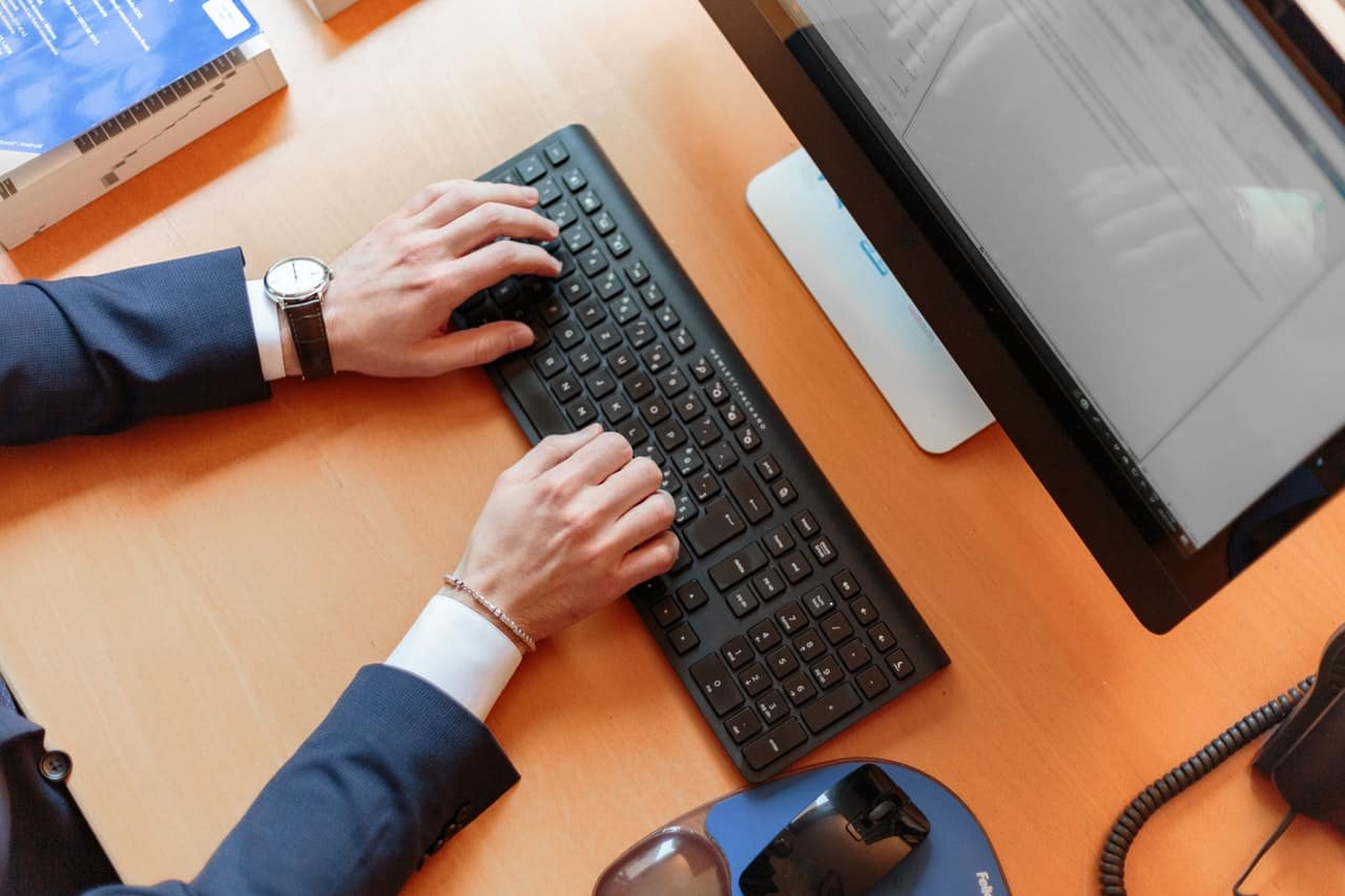 hands typing on a keyboard