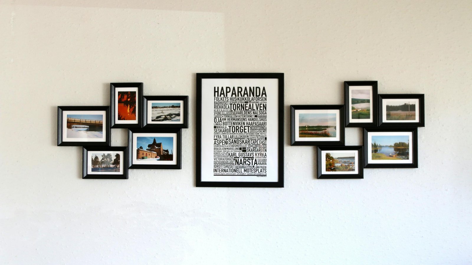 Elegant wall art with black frames showcasing Haparanda themes and landscape photos.